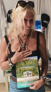 Teri Gibney holds a copy of Coastal Living magazine with her St. John cottage on the front cover.