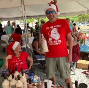 Heather Grant assists Stuart Locklair at his Coquito Festival debut, 2018. (Anne Salafia photo)