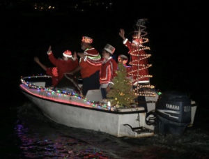 The Randall family show off its usual Christmas cheer – and matching suits – during the lighted boat parade.