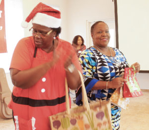 Organizer Diamon Carter, left, and donor Silva Gibbs hand out gifts.