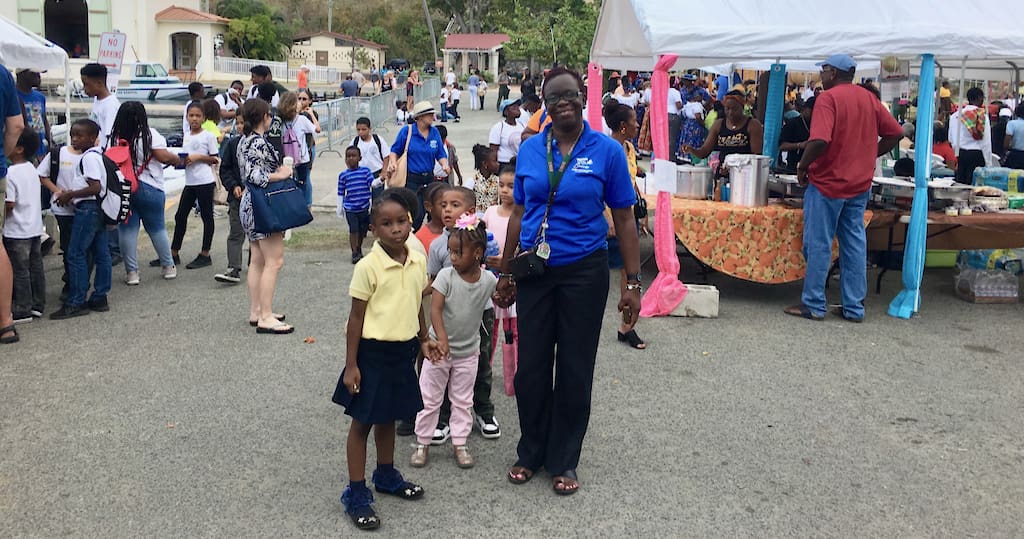Sprauve School kindergarten teacher Lucille Parsons leads the littlest students back to school after a busy morning at the VINP Folklife Festival.