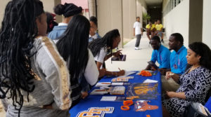 Student look at materials from Lincoln University at Tuesday's college fair. (Photo provided by Cenita Heywood)