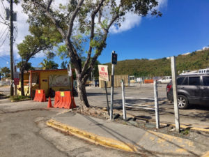 A barrier closes the entrance to parking lot at the Victor Sewer Marine Facility across from the post office in Cruz Bay.