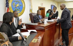 VIHFA Executive Director Daryl Griffith, far right, interact with lawmakers during a hearing break Tuesday. (Photo by Barry Leerdam for the V.I. Legislature)
