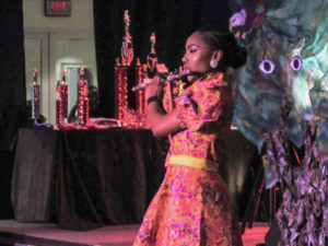 Kimorah-Lin Blackett plays the flute during the talent segment of the pageant.