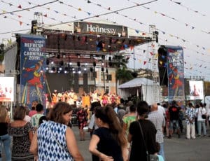 A crowd listens to the opening speakers open he Carnival Village Friday night.