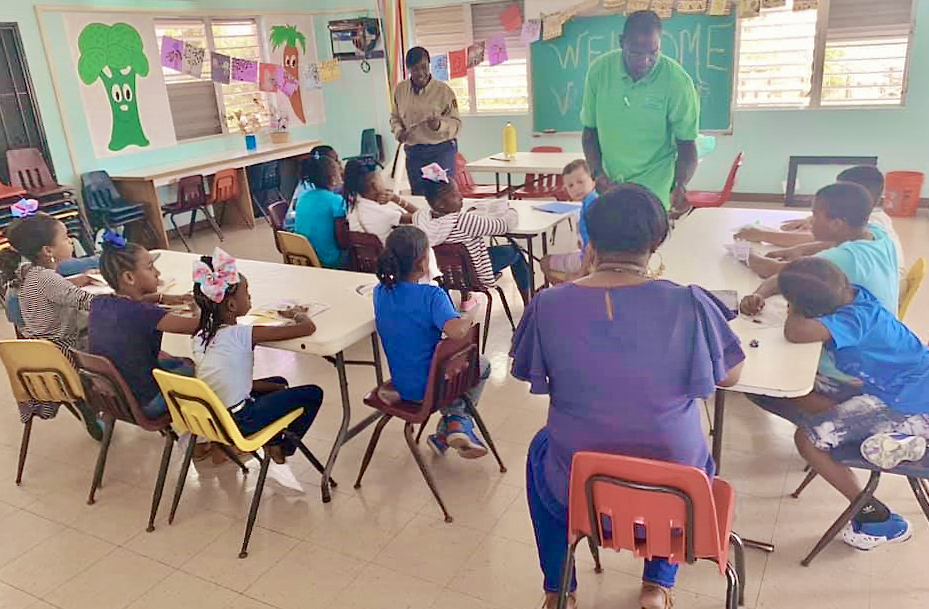 Field technician Ellisha Williams, Principal Rosemond Lawrence-Creighton and teacher Petra Wilson work with St. Croix with students at S. Croix Christian Academy. (Photo by V.I. Next Generation Network)