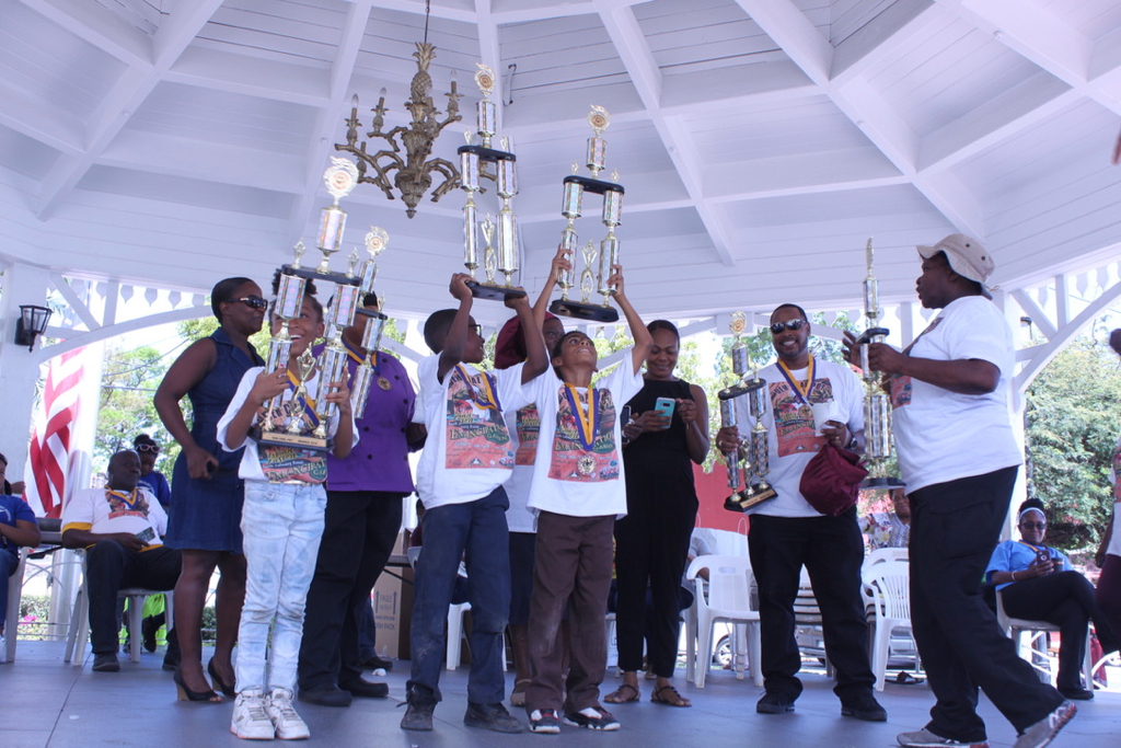 Students from the Seventh Day Adventist School raise their large trophies after winning the Dem Coal Pot youth culinary event with a score of 375 points. (Bethaney Lee photo)