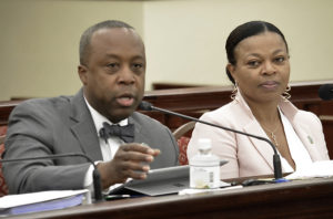 Acting Finance Commission Kirk Callwood and Acting Budget Director Jenifer O'Neal discuss plans for a budgetary windfall at Tuesday's Finance Committee hearing. (Photo by Barry Leerdam, V.I. Legislature)