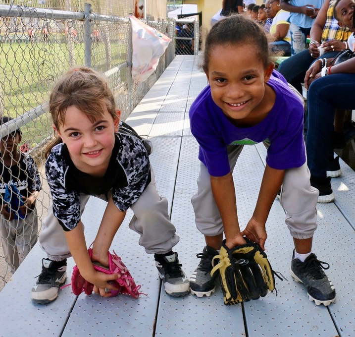 Friends and classmates at Pearl B. Larsen Elementary School, Bella Karalius, at left withg her prized pink glove, and Ta’Liyah Pop show their playing stance after the game. Bella plays for the Panthers and Ta’Liyah for Diamond Dolls. (Linda Morland photo)