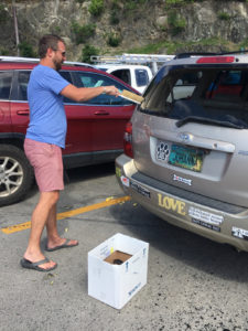 Stephen Libbey cleans glass from a co-worker's car. (Amy Roberts photo)