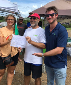 Gaylin Vogel, left celebrates winning first place Saturday with Rob Upson the local organizer for National Drive Electric Week, and Drive Green V.I. managing partner Adrien Austin. (Photo by Corinne van Rensselaer)