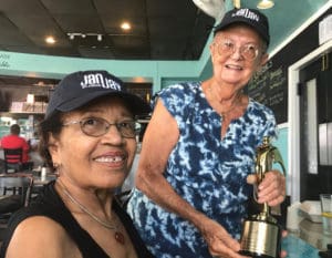 Roberta Knowles, left receives a gold trophy from Joan Keenan for her work on 'Proudly We Served.' (Photo by Elisa McKay)