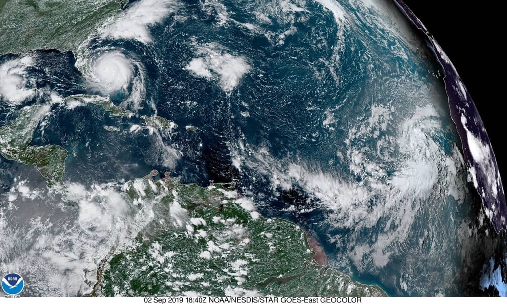 Satellite photo shows, from left, a low-pressure system moving west across the Gulf of Mexico, Hurricane Dorian smashing across the Bahamas and bearing down on the U.S. coast, and to the far right, a tropical wave with a 90 percent chance of forming a tropical depression by week's end. (NOAA photo)