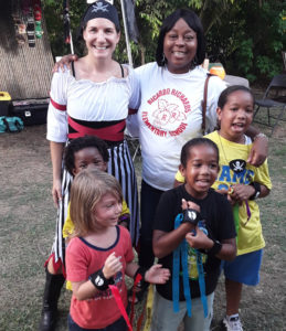 DoDat Founder Nora James poses with children and Principal Avion Matthew-James from Ricardo Richards School. (Source photo by Darshania Domingo)