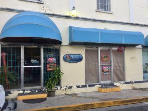 Molly Buckley of St. Croix Underwater Bluewater Adventures in downtown Christiansted is one of several business owners who said power flucations have damaged equipment. (Source photo by Susan Ellis)