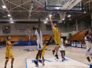 Ermias Nega, who scored 35 points against University of Baymon, goes in for a layup during the game. (Source photo by Kyle Murphy)