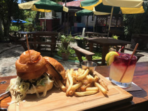A Whiskey Burger plated on signature wood plank makes a tempting visual. (Source photo by Teddi Davis)