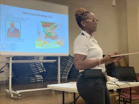 Juanita Johannes, assistant director for the Division of Environmental Health, gives a presentation about safe food handling. (Photo submitted by Government House)