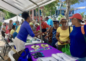 Charmaine Mayer hands out health information to St. John residents.