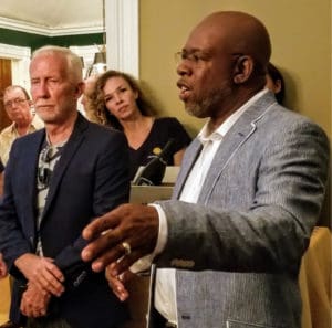 Historic Trust Directors Felipe Ayala, right, and Philip Sturm, left, tell guests about the home’s history. (Source photo by Bethaney Lee)