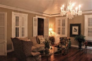 A chandelier hangs from the center of the larger of the two living rooms. (Source photo by Bethaney Lee)