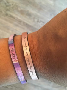 Two of the YAG Collection bracelets available for sale. ALl proceeds benefit the organization. (Source photo by Denise Lenhardt-Benoit)