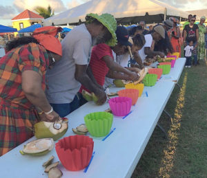Contestants dig into the coconut jelly scoop competition during 2018's Crucian Coconut Festival. (Submitted photo)