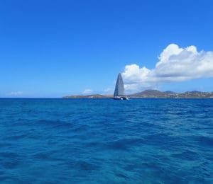 Sailboat makes its way past St. Thomas. (Source photo by Dave MacVean)