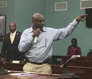 Carlton Dowe gestures to staff members while Sen. Steven Payne looks on at Monday's meeting. (Source photo by Amy Roberts)