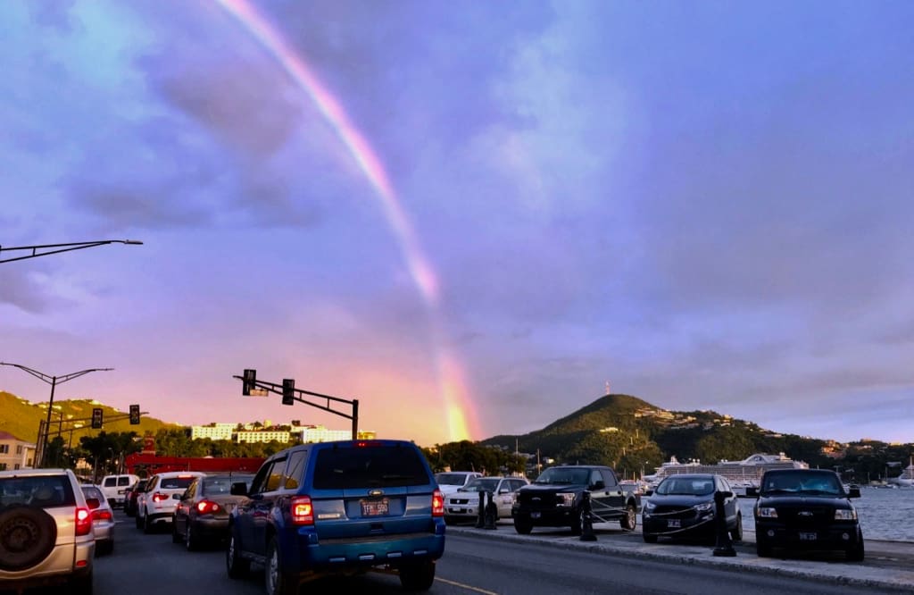 A rainbow arches over Charlotte Amalie before Friday’s event got underway. (Source photo by James Gardner)