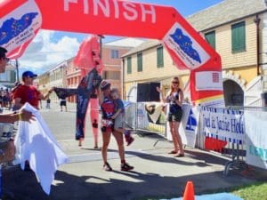 Ester Ellis carries her baby across the finish line Sunday. (Source photo by Susan Ellis)