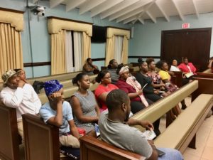 Young St. John residents listen while police officials outline the steps to become an officer. (Source photo by Amy Roberts)