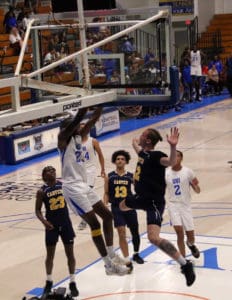 Muhammadu Jawaru dunks the ball over a Carver Cougar defender. (Source photo by Kyle Murphy)