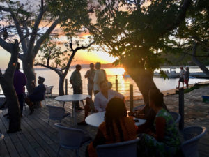 Guests enjoy the sunset from the deck at Lovango Cay. Source photo by Amy H. Roberts)