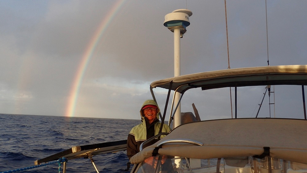 Laura Masterson smiles as she enters Caribbean waters under a rainbow on March 2. (Photo by Bruce Masterson.)