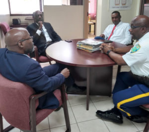From left, Commissioner Trevor Velinor, St. Thomas District Police Chief Ludrick Thomas, Deputy Commissioner of Police Operations Dr. Celvin Walwyn, and Assistant Commissioner of Police Mario Brooks discussing COVID-19 matters. (VIPD photo)