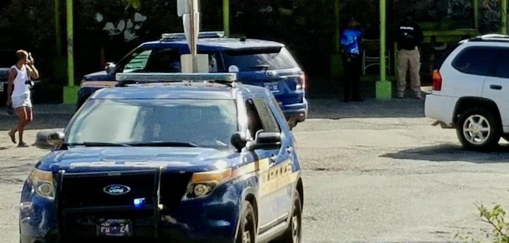 Police secure the scene of Friday's fatal shooting in Hospital Ground. (Photo by W. Bostwick)