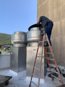 A worker installs a new exhaust system on the roof of the Schneider Hospital. (Photo provided by Darryl Smalls)