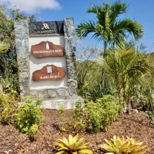 The newly erected sign for Frenchman’s Reef and Noni Beach sits below the turnoff to the shuttered resort. (Source photo by Bethaney Lee)