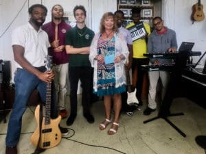 Street Level V.I. founder Priscilla Lynn presents donation to Gifft Hill School on St. John. From left to right is: music teacher Dennison Blackett, and students Eion Roberts, Christian Foust, Ohsemenard Vales, A.J. Phillips and Ricquan Charlemagne. (Photo provided by Gifft High School)