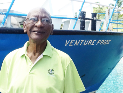 In a 2012 photo, Rodney Varlack stands in front of one of his vessels, Venture Pride. (St. John Tradewinds photo)