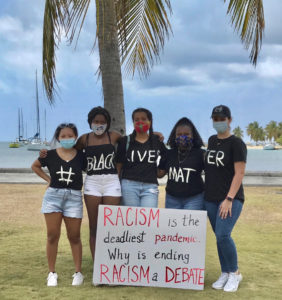 From left, Alessandra Evangelista, Simone Hodge,Saba Alfred,Anaijah Peters and Mariam Hamed spell out their message Saturday. (Photo by Wanda Evangelista)
