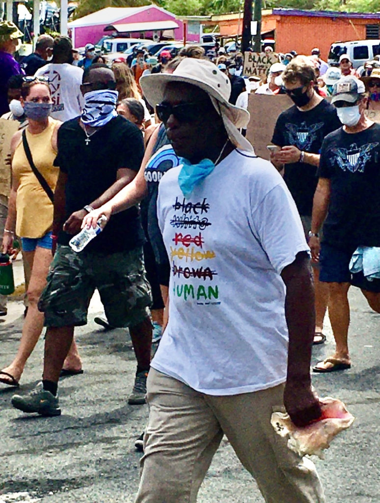 Conch blower Emanuel 'Mano' Boyd where's a 'Human' T-shirt. (Photo by Lisa Etre)