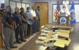 At a news conference Tuesday, St. Croix Police Chief Sidney Elskoe, at the podium, announced four arrests and the seizure of 10 illegal firearms, which were on display. (Source photo by James Gardner)