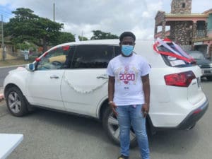 Trey Francis, vice president of the St. Croix Central High School class of 2020, prepares for the motorcade (Source photo by Diana Dias)