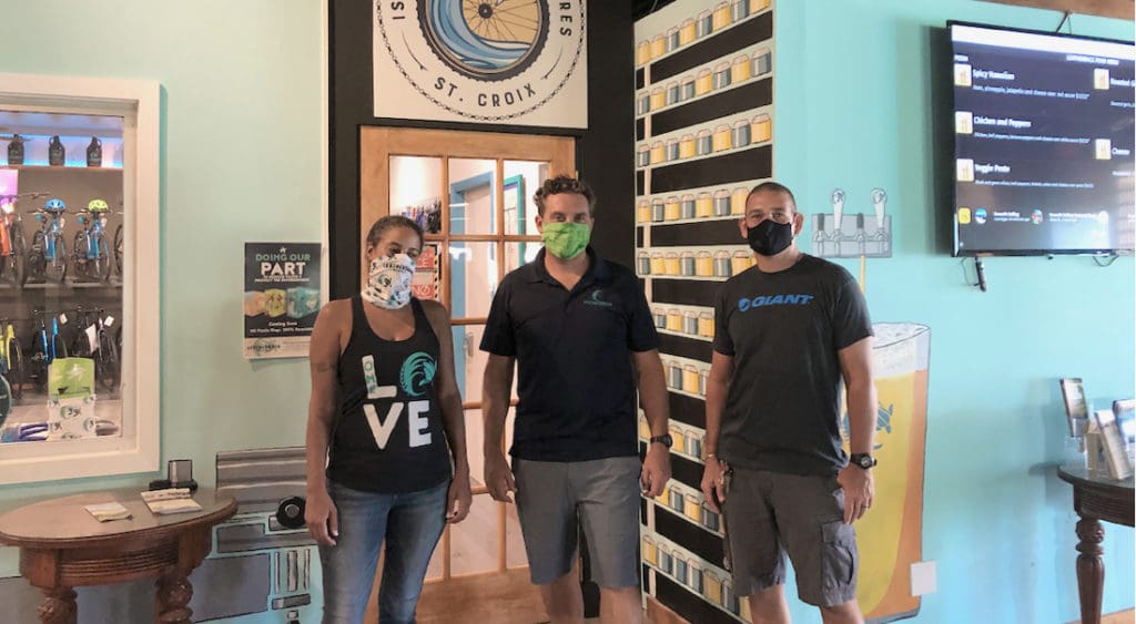 Ivy Hunter, Aaron Hutchins and David Morales stand at the new Leatherback store front. (Source photo by Susan Ellis)