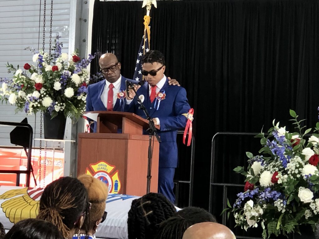 Son Daryl George Jr., and brother Victor Barry read the eulogy for Fire-EMS Director Daryl George Sr. at his funeral on Saturday. (Source photo by Judi Shimmer)