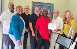 L-R: Luis Llanos, FHC dental manager, Masserae Sprauve, FHC CEO, Dr. Stephanie Brown, FHC dentist, Dr. Robert Good, FHC chief dental officer and Stanley Brown, FHC board member, accept a check for dental scanners from David and Tina Beals, executors of the Bennie and Martha Benjamin Foundation. (Submitted photo)