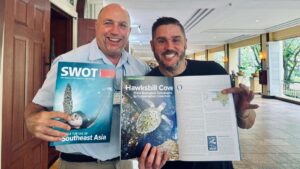 From left, Dr. Paul Jobsis, sea turtle biologist and director of research at The Hawksbill Project and Scott Eanes, founder of The Hawksbill Project displaying SWOT magazine feature "Hawksbill Cove: From Ecological Catastrophe to Conservation Classroom." (Photo courtesy Scott Eanes)